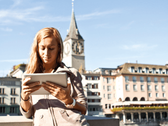 Young woman by the river of Zurich using a digital tablet.Sunny spring day.http://www.mediafire.com/convkey/ebb9/to5djv8cz1fu159zg.jpg