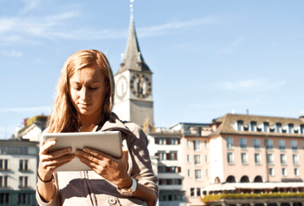 Young woman by the river of Zurich using a digital tablet.Sunny spring day.http://www.mediafire.com/convkey/ebb9/to5djv8cz1fu159zg.jpg