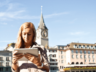 Young woman by the river of Zurich using a digital tablet.Sunny spring day.http://www.mediafire.com/convkey/ebb9/to5djv8cz1fu159zg.jpg